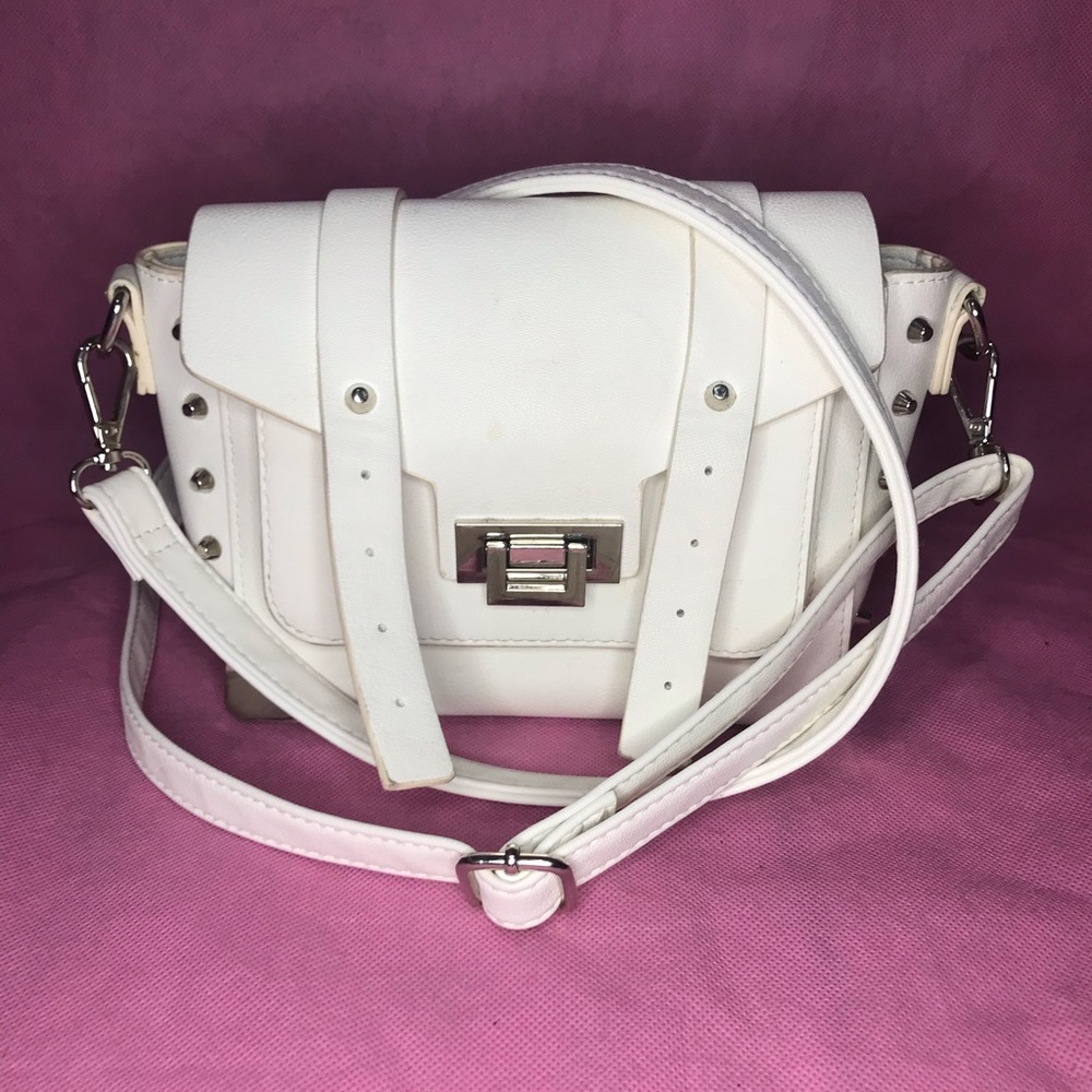 White buckle strap cross body purse.